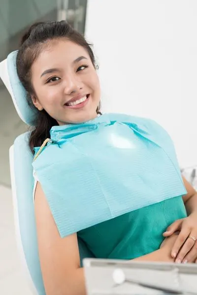 woman smiling during her dental bonding appointment at Gina Biedermann DDS