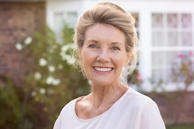 woman smiling after getting dental implants at Gina Biedermann DDS in Keller, TX
