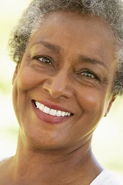 woman showing off her new dentures from Gina Biedermann DDS in Keller, TX