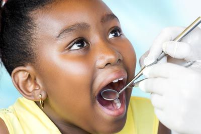 young girl receiving dental care at the office of Gina Biedermann DDS