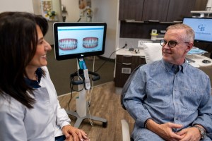 Dentist showing digital smile simulation to patient
