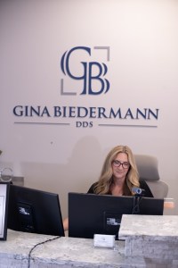 Gina Biedermann DDS front desk with staff member seated